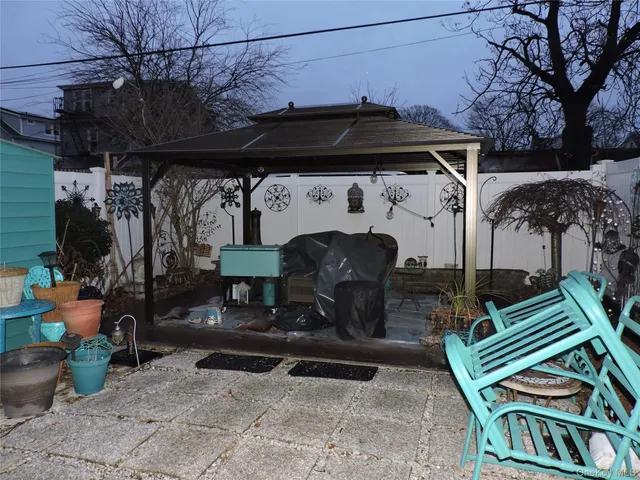 a view of a patio with table and chairs and potted plants