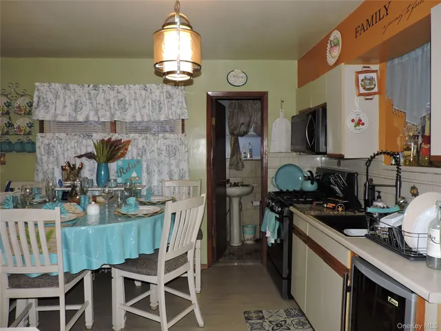 a kitchen with a table chairs stove and cabinets