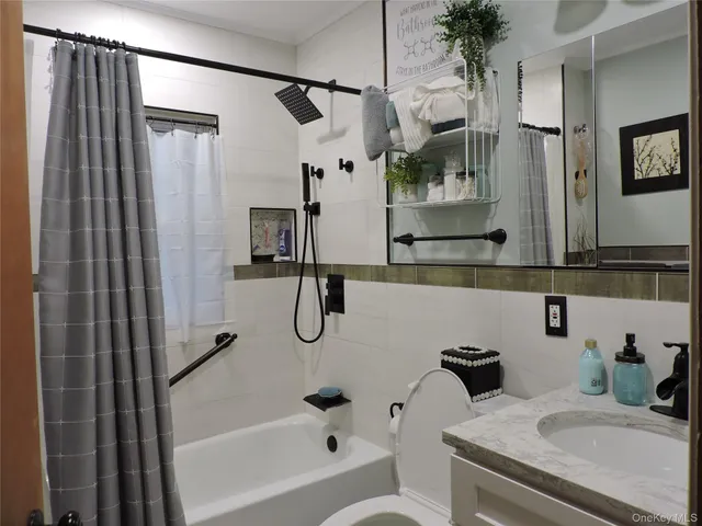 a bathroom with a granite countertop sink a mirror and shower
