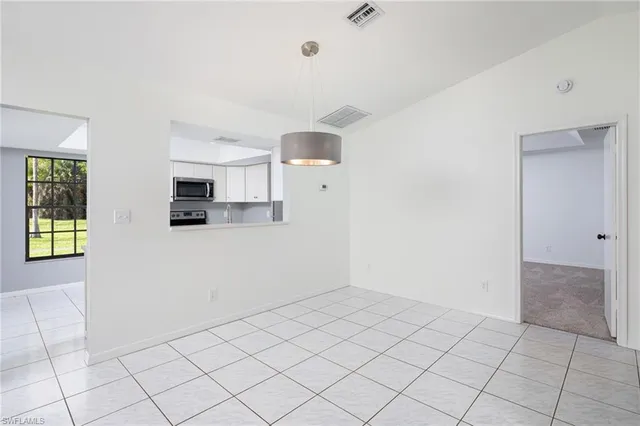 a view of a kitchen with microwave and cabinets