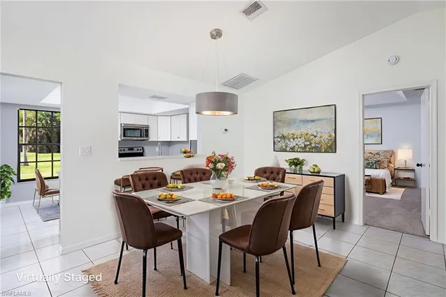 a dining room with a wooden table and chairs