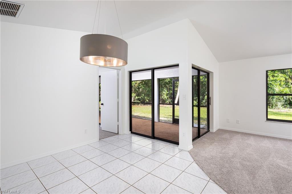 5671 Green Boulevard Naples, FL 34116 - Photo 13 of 37 a view of an empty room with a window