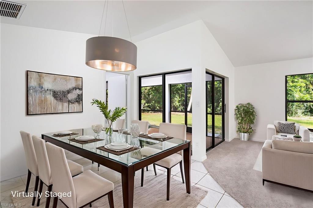 5671 Green Boulevard Naples, FL 34116 - Photo 14 of 37 a view of a dining room with furniture window and outside view