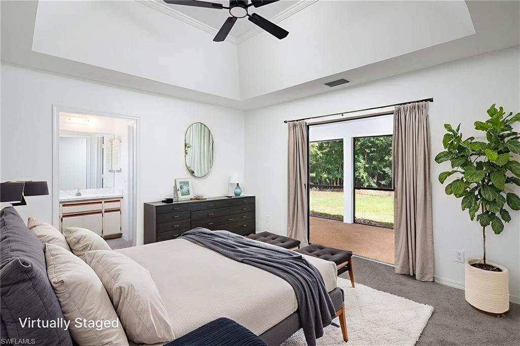 5671 Green Boulevard Naples, FL 34116 - Photo 20 of 37 a bedroom with a bed and a potted plant with a large window