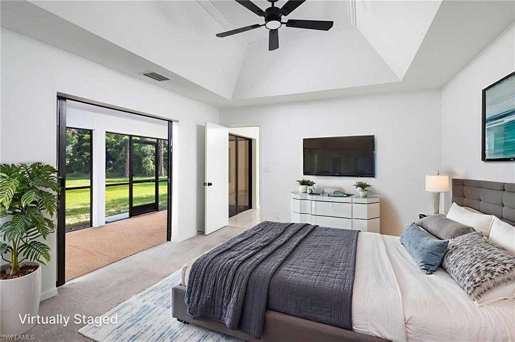 5671 Green Boulevard Naples, FL 34116 - Photo 22 of 37 a bedroom with a bed and a flat screen tv