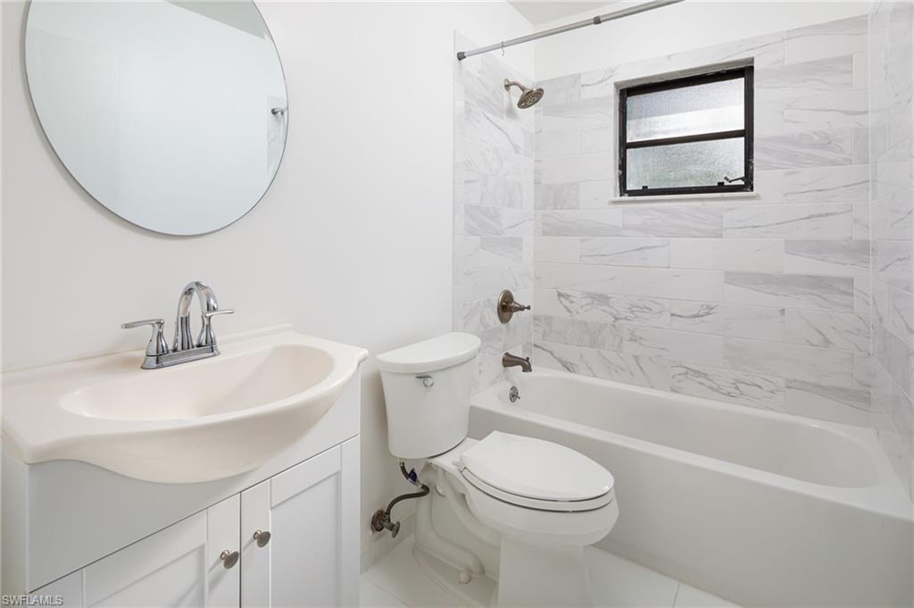 5671 Green Boulevard Naples, FL 34116 - Photo 25 of 37 a bathroom with a sink a toilet and a bathtub