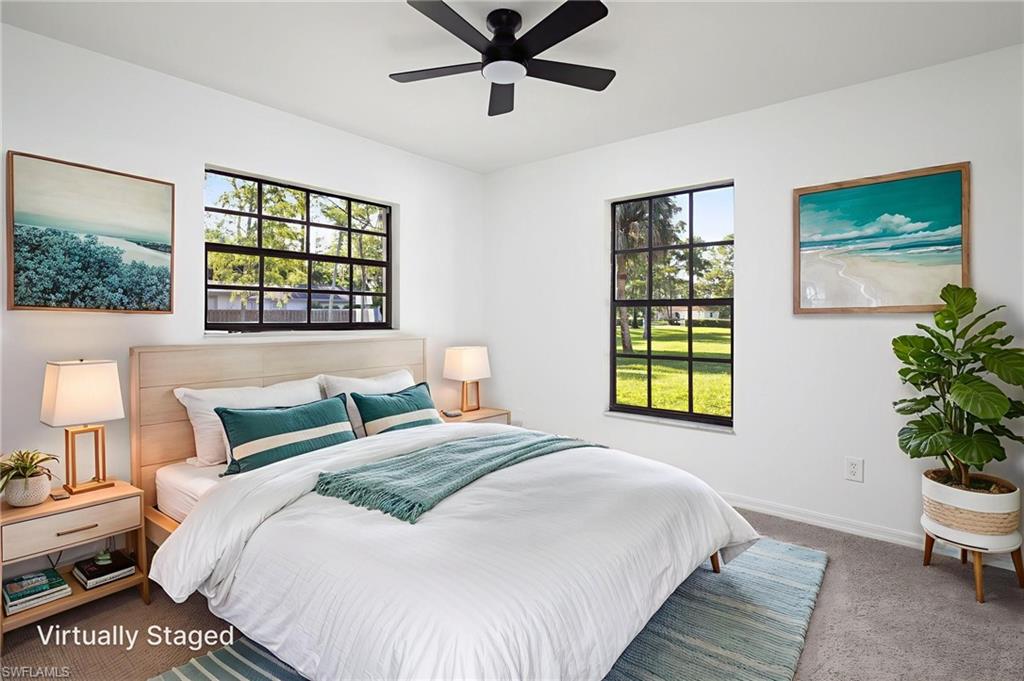 5671 Green Boulevard Naples, FL 34116 - Photo 27 of 37 a bedroom with a bed and a window