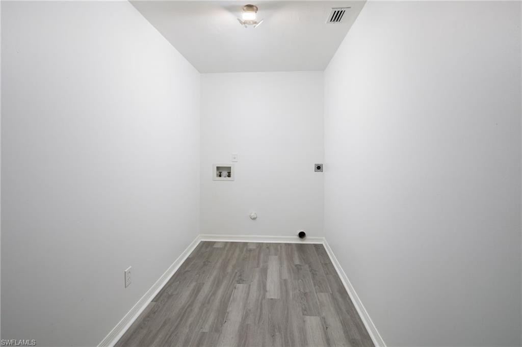 5671 Green Boulevard Naples, FL 34116 - Photo 28 of 37 a view of a room with wooden floor