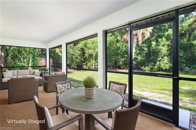 a dining room with furniture window and outside view
