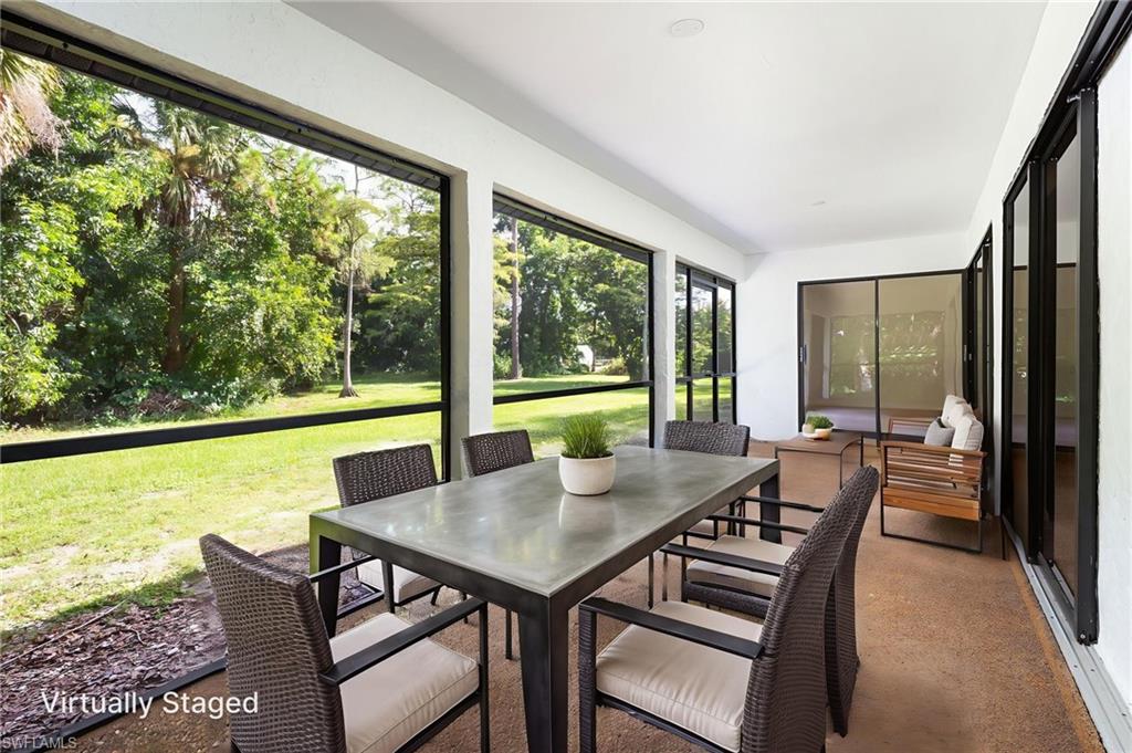 5671 Green Boulevard Naples, FL 34116 - Photo 33 of 37 a view of a city from a dining room with furniture and window