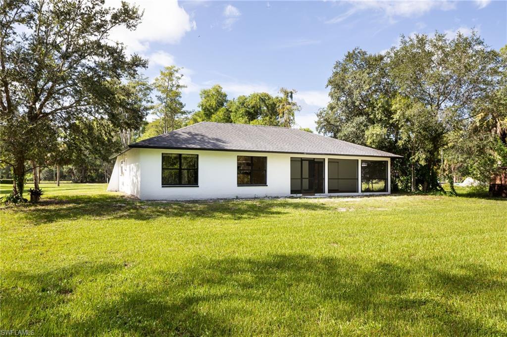 5671 Green Boulevard Naples, FL 34116 - Photo 36 of 37 a front view of a house with a garden