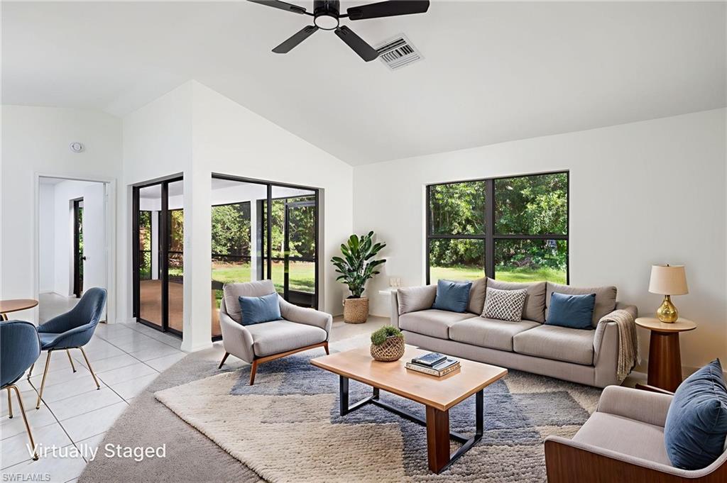 5671 Green Boulevard Naples, FL 34116 - Photo 6 of 37 a living room with furniture and a large window
