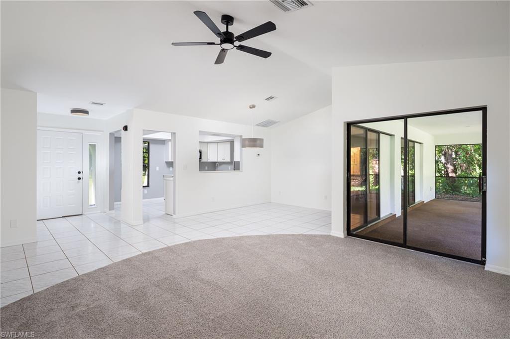 5671 Green Boulevard Naples, FL 34116 - Photo 9 of 37 a view of an empty room with a window and a kitchen