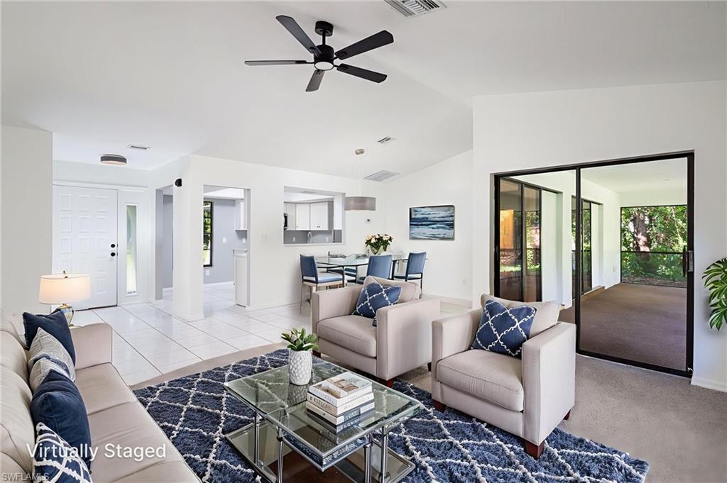 5671 Green Boulevard Naples, FL 34116 - Photo 10 of 37 a living room with furniture and a rug