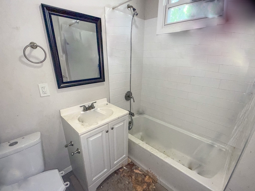 23 Eldert Street Springfield, MA 01109 - Photo 11 of 27 a bathroom with a toilet sink and mirror with bathtub