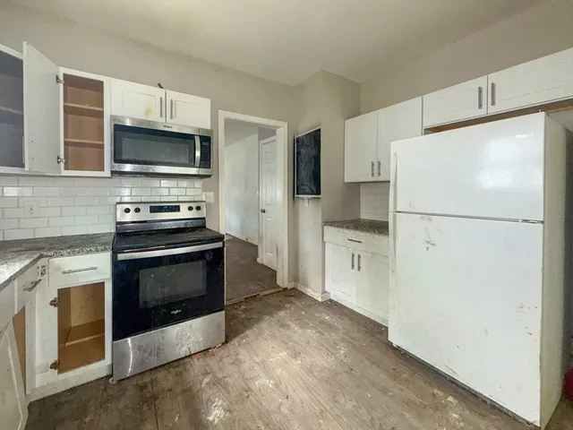 a kitchen with stainless steel appliances a refrigerator stove and microwave