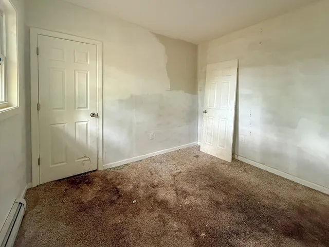 an empty room with closet area