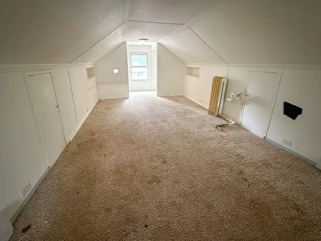 a view of a big room with closet and windows