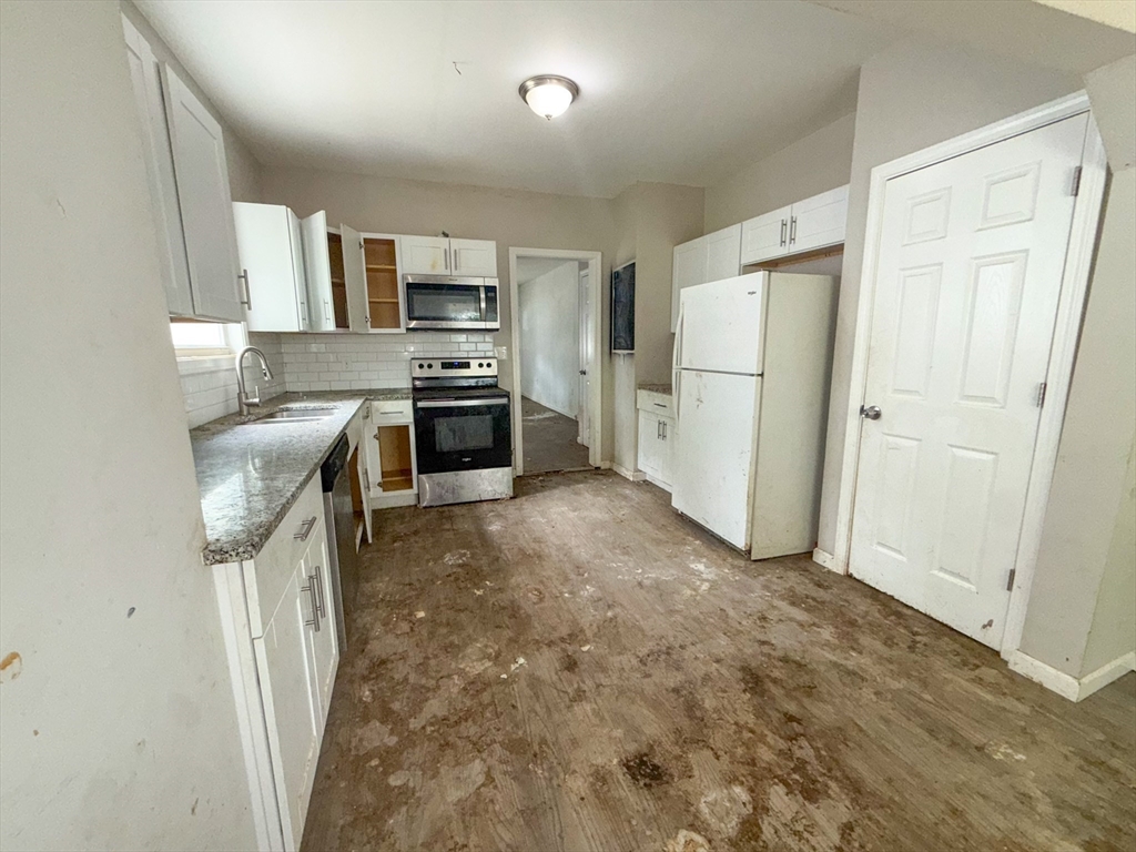 23 Eldert Street Springfield, MA 01109 - Photo 25 of 27 a kitchen with stainless steel appliances granite countertop a refrigerator stove and sink