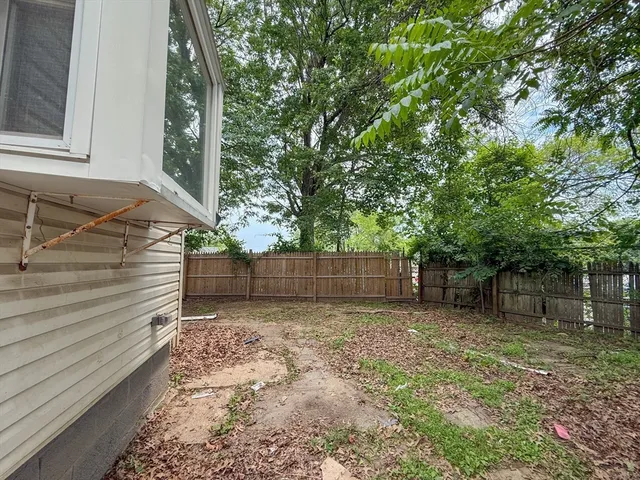 a view of a backyard with a tree