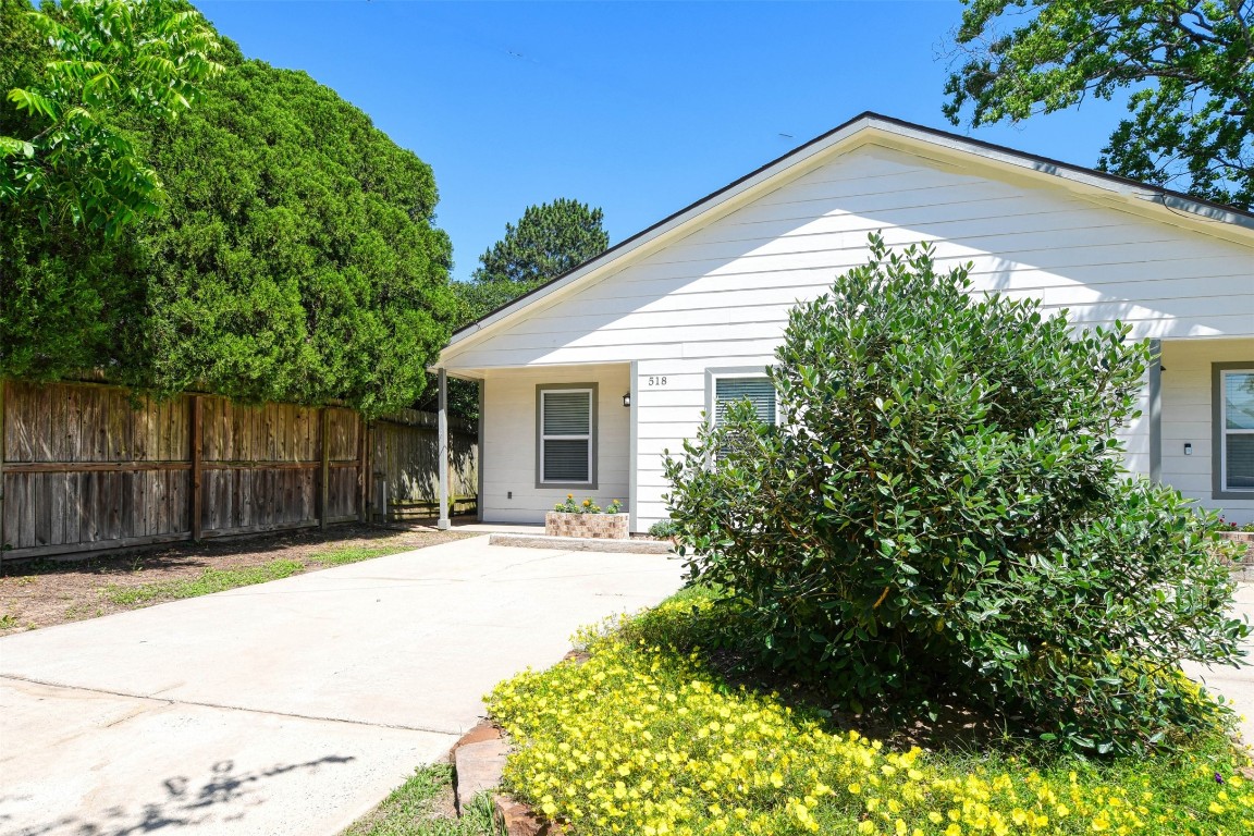 518 Moore Street Tomball, TX 77375 - Photo 1 of 18 a backyard of a house with table and chairs