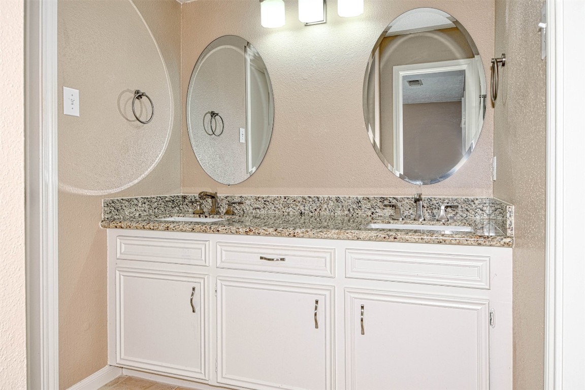 518 Moore Street Tomball, TX 77375 - Photo 12 of 18 a bathroom with a granite countertop sink and mirror