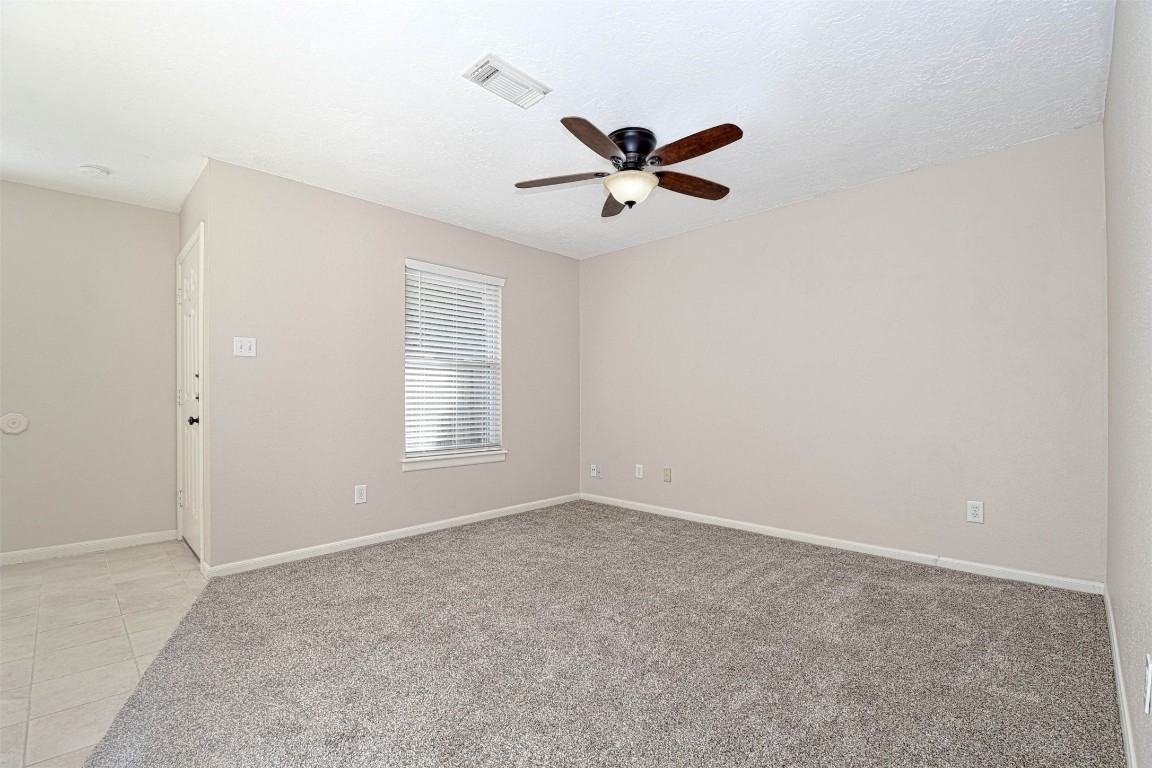 518 Moore Street Tomball, TX 77375 - Photo 14 of 18 a view of room with hardwood floor and window