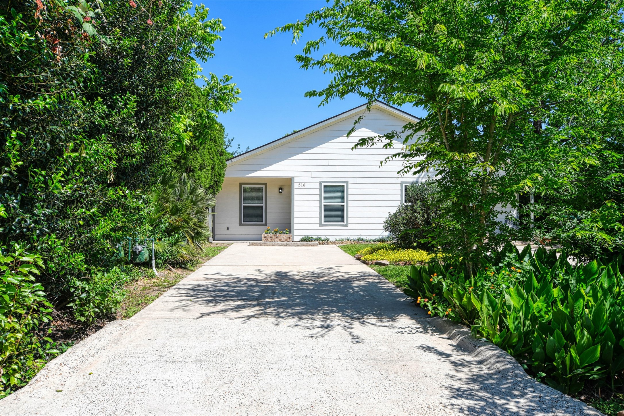 518 Moore Street Tomball, TX 77375 - Photo 17 of 18 The duplex is located at the end of a street with greenery all around.