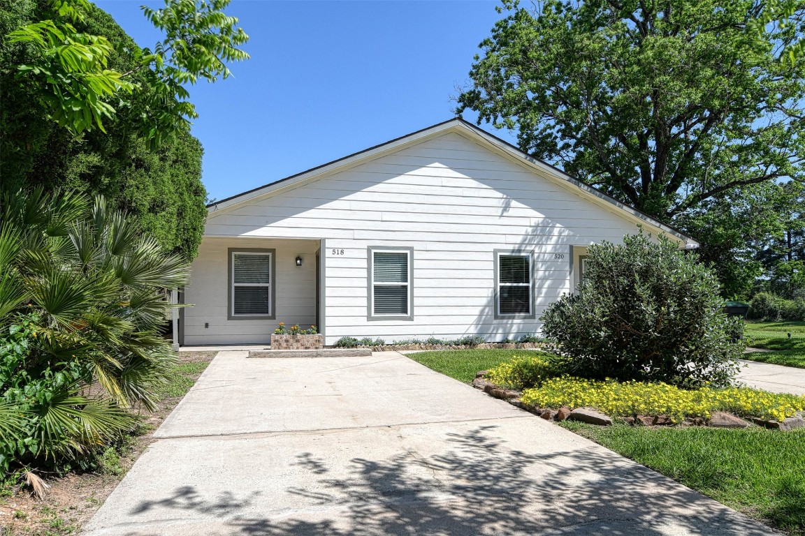 518 Moore Street Tomball, TX 77375 - Photo 2 of 18 a front view of a house with a garden