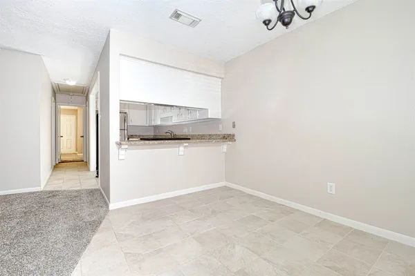 a view of a room with a sink and mirror