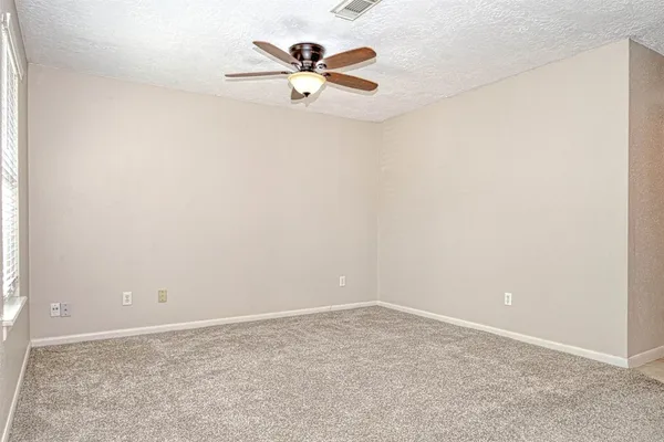 a kitchen with white cabinets and refrigerator