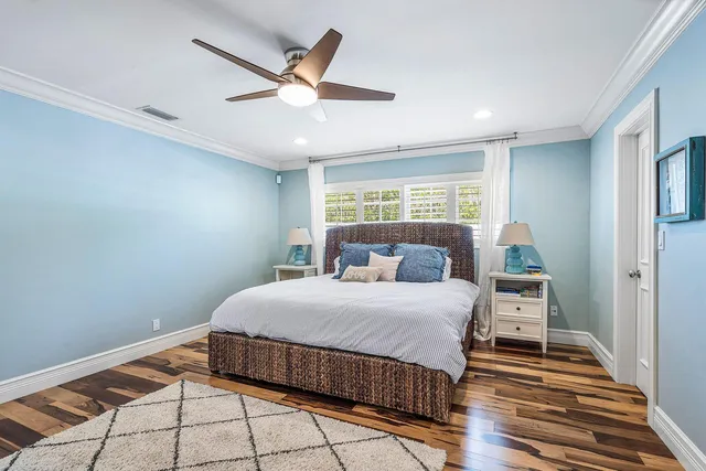 a bedroom with a large bed and a chandelier