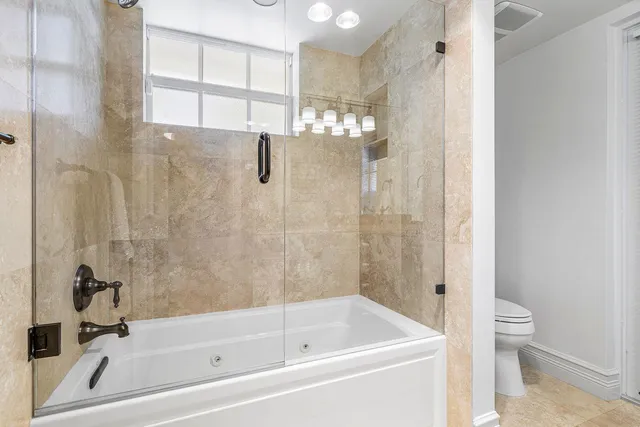 a bathroom with a bathtub and a shower