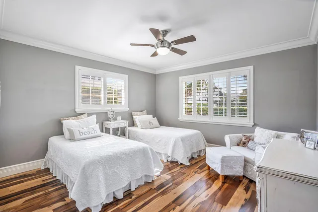 a bedroom with two beds and a window