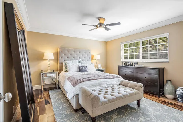 a bedroom with a large bed and a chandelier