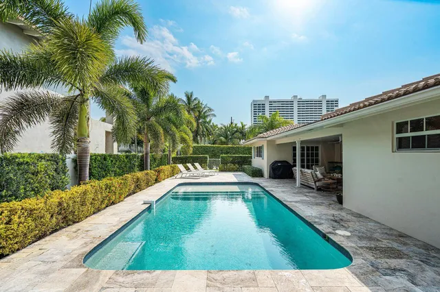a swimming pool with outdoor seating and yard