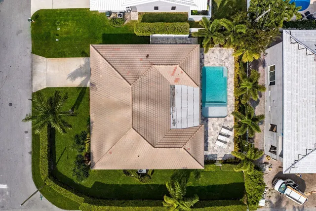 an aerial view of a house with yard
