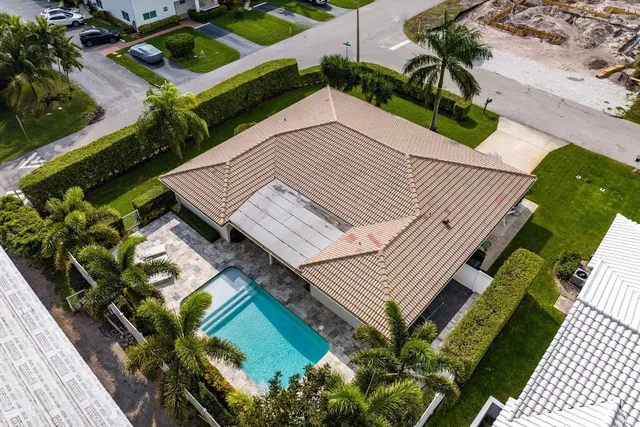 an aerial view of a house with a yard