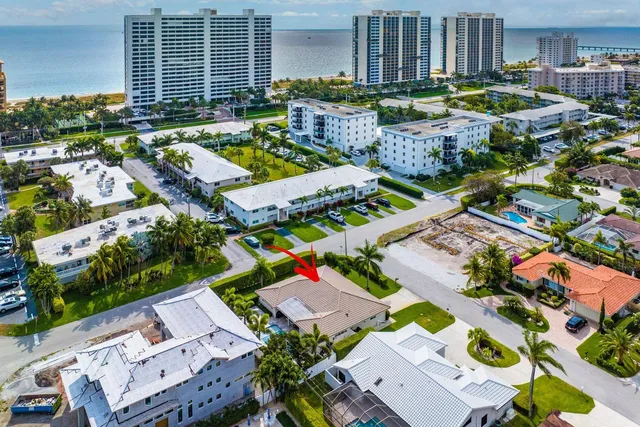 an aerial view of multiple houses with yard