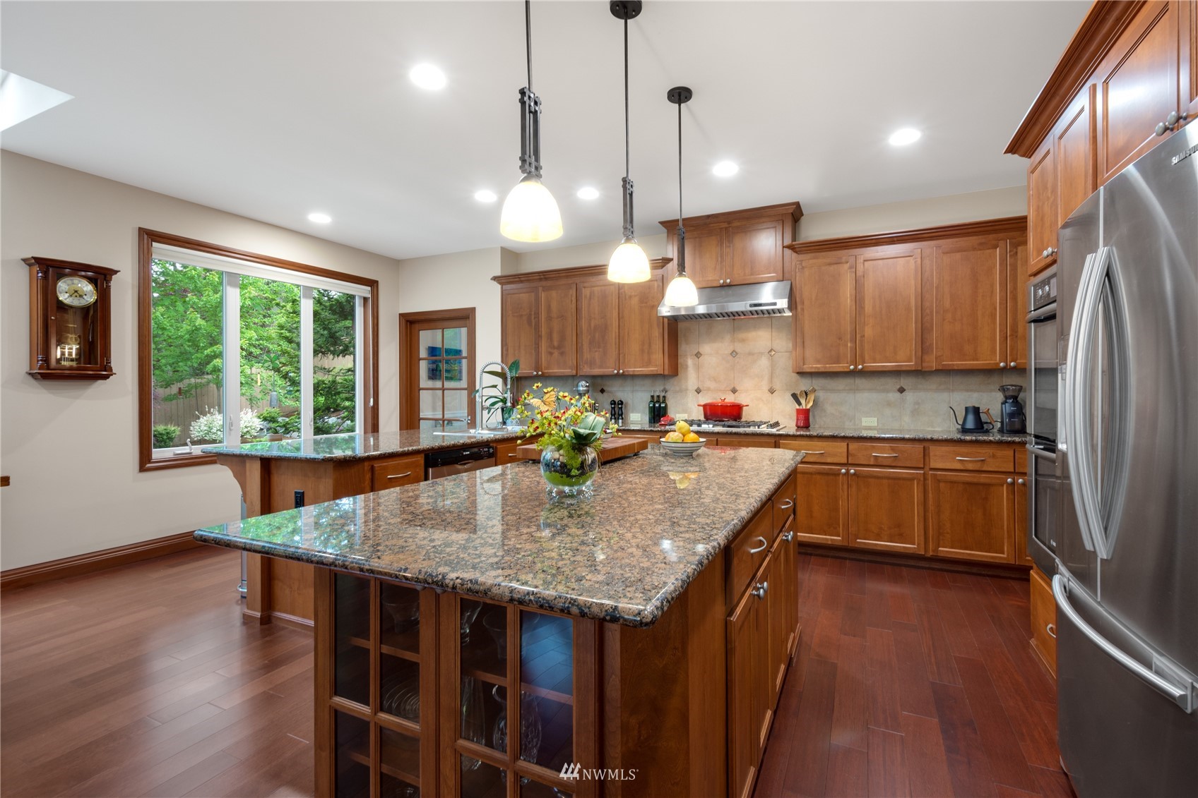 4123 221st Place Southeast Bothell, WA 98021 - Photo 6 of 28 a kitchen with kitchen island granite countertop a stove a sink a center island and wooden floor
