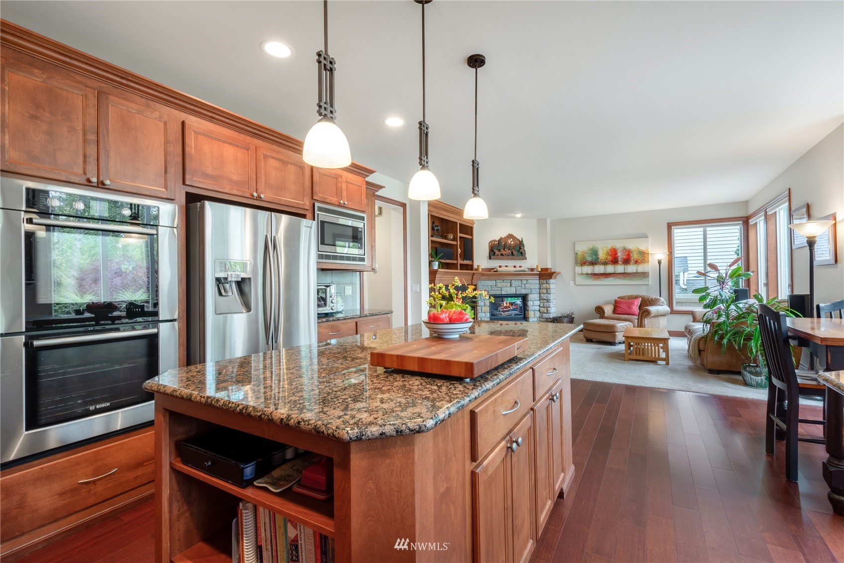 4123 221st Place Southeast Bothell, WA 98021 - Photo 8 of 28 a kitchen with stainless steel appliances granite countertop a sink a stove and a wooden floors