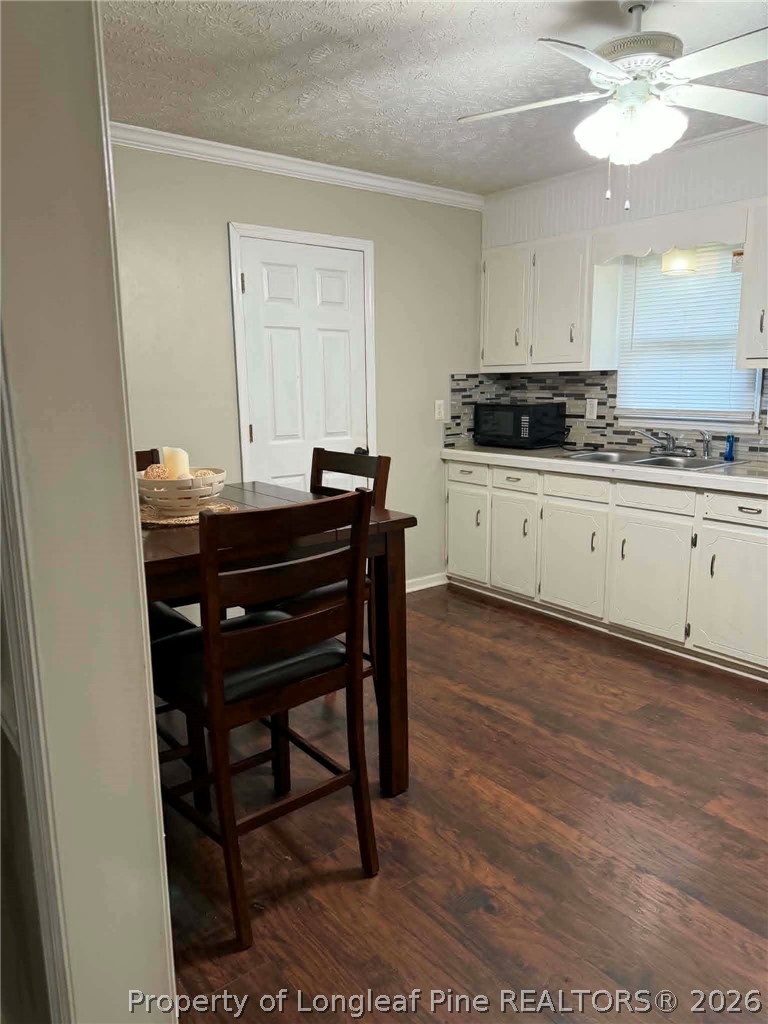634 Dallas Road Lumberton, NC 28358 - Photo 7 of 27 a kitchen with a sink cabinets and wooden floor