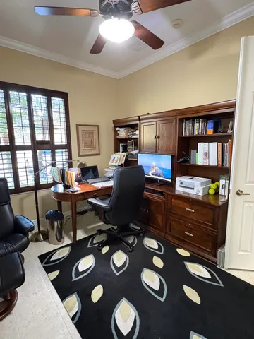 a living room with furniture and a bookshelf