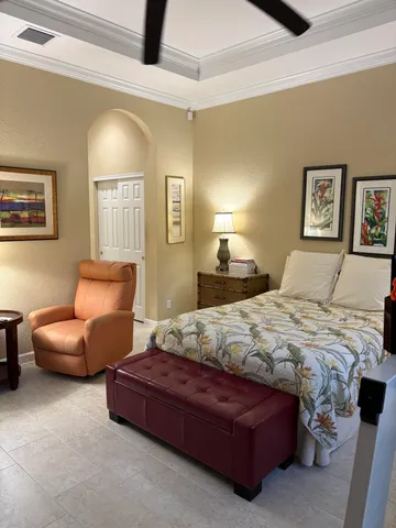 a bedroom with a bed couch and window