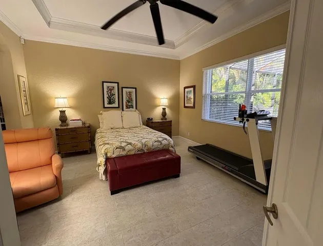 a bedroom with a bed couch and window