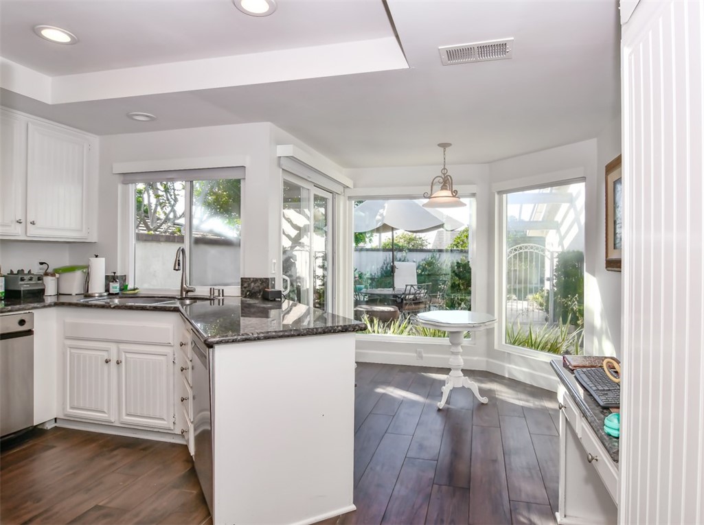 26 Shoal Drive Corona del Mar, CA 92625 - Photo 12 of 37 a open kitchen with granite countertop a sink stove and wooden floor