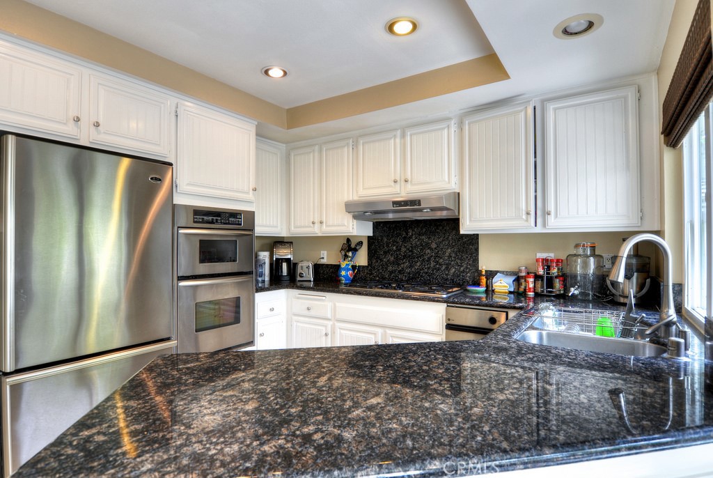 26 Shoal Drive Corona del Mar, CA 92625 - Photo 13 of 37 a kitchen with stainless steel appliances granite countertop a refrigerator sink and stove