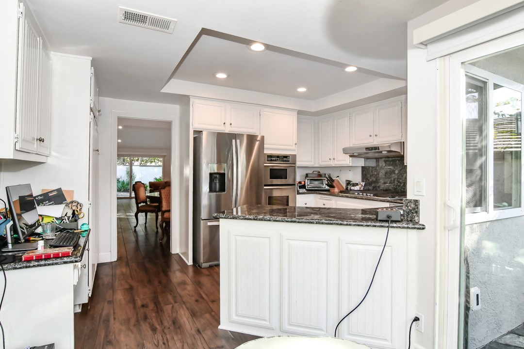 26 Shoal Drive Corona del Mar, CA 92625 - Photo 15 of 37 a kitchen with stainless steel appliances granite countertop a refrigerator and a stove top oven