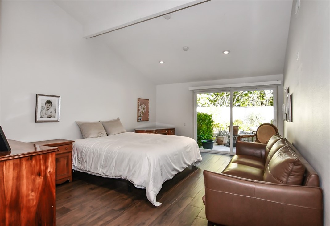 26 Shoal Drive Corona del Mar, CA 92625 - Photo 23 of 37 a bedroom with a large bed and a couch