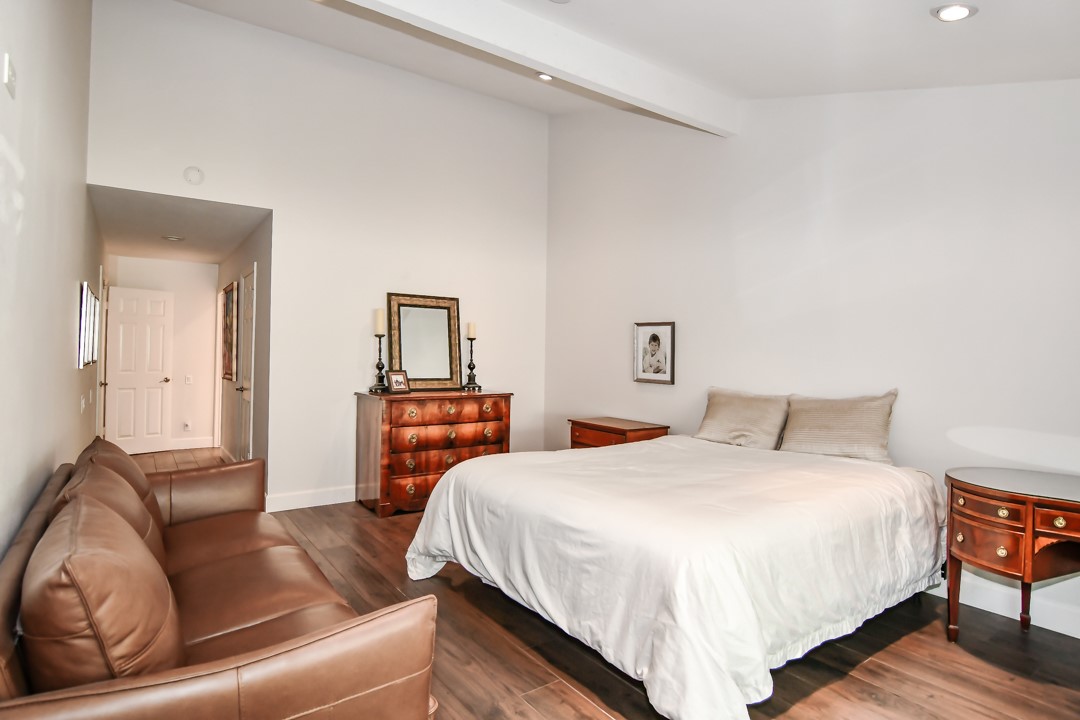 26 Shoal Drive Corona del Mar, CA 92625 - Photo 24 of 37 a bedroom with a bed and wooden floor